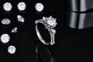 Macro detail of 1 carat moissanite ring with bow-knot design on black reflective surface