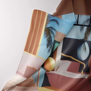 Detail view of a silky Bohemian wall tapestry with geometric prints and rolled edges