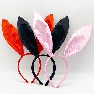 Detailed view of red, black, and pink satin bunny ear headbands with fabric texture
