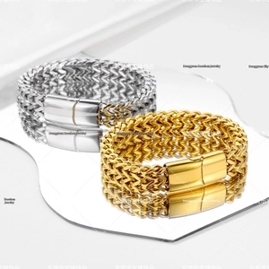Detail of woven stainless steel chain bracelets with polished magnetic metal clasps
