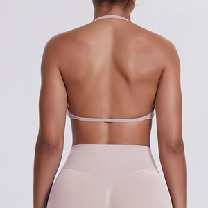 Detail of nude pink halter sports bra with thin back strap and high waist yoga leggings