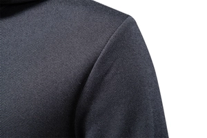 Close-up of high-density dark grey fabric texture and shoulder stitching on a men's hoodie