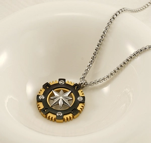 Macro shot of industrial star compass pendant with N/E/S/W engravings on square box chain