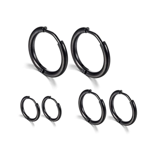 Three pairs of black stainless steel hoop earrings in varying sizes on white background
