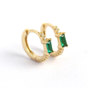 Gold rectangular green emerald earring with white cubic zirconia accents in macro view
