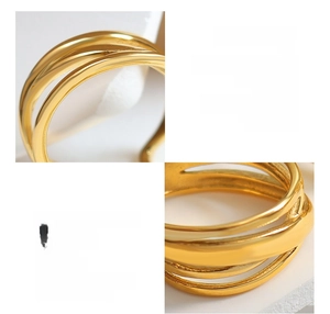 Detail of multi-layer 18K gold plated titanium steel ring with irregular crossover design
