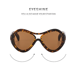 Close-up of tortoise shell oversized sunglasses with brown lenses and fluid curved frame