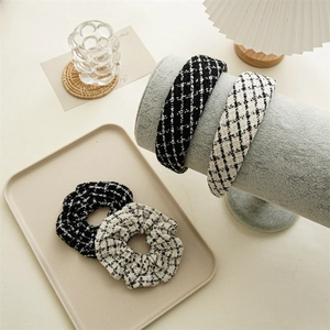 Detail of black and white tweed scrunchies and headbands on a display stand