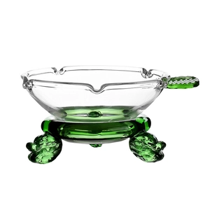Transparent glass tea filter with a unique green dragon base and matching green handle