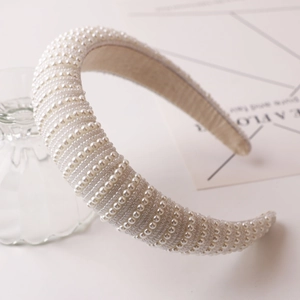 Detailed view of handmade faux pearl padded headband with elegant vintage texture