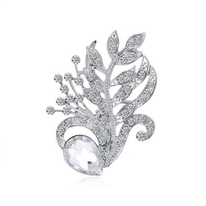Macro shot of silver butterfly brooch with sparkling crystals and a teardrop stone