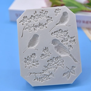 Octagonal silicone mold with birds and flowers relief on a blue background
