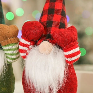 Close-up of a festive Christmas gnome doll with plaid hat and mittens covering eyes