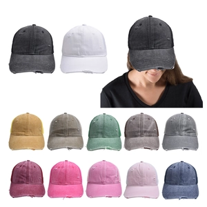 Close-up of distressed cotton baseball caps with breathable mesh and frayed brim detail
