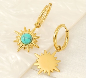 Detail of 18K gold sunburst star earrings with turquoise stone inlay and polished back