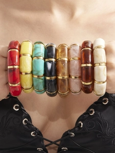 Detail of multi-color wide resin stretch bracelets with gold metal link connectors