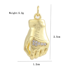 Detail view of 18K gold plated palm pendant with dimensions 2.5cm by 1.2cm and 5.2g weight