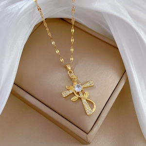 Macro detail of gold cross rose necklace with sparkling zircon pavé on luxury display