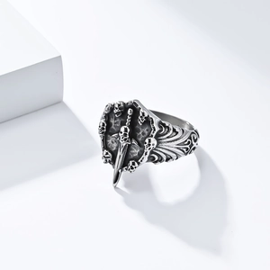 Macro detail of Gothic skull shield and sword engravings on vintage steel ring