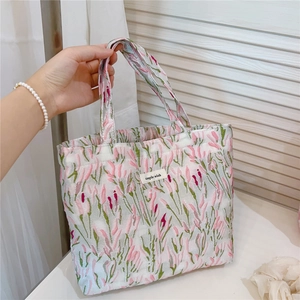 Detail showing pink tulip jacquard fabric and simple wish label on the handbag