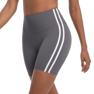 Detail of high-waisted yoga shorts with side stripes and breathable compression fabric