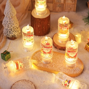 Detail of LED Christmas candles featuring Santa and snowman figures with warm glowing light
