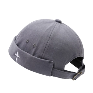 Dark grey docker cap with white cross embroidery and adjustable metal strap