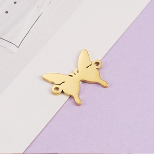 Detailed view of a golden mirror-polished butterfly connector charm for DIY jewelry making