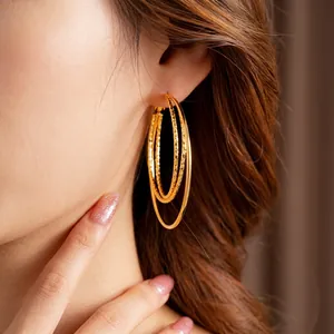 Three-layer gold hoop earrings with polished and diamond-patterned textured rings