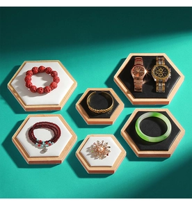 Detailed view of hexagonal bamboo jewelry display trays with black and white cushions