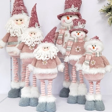 Pink and white plush Christmas gnome dolls with sequined hats and striped legs