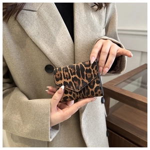 Detailed close-up of leopard print envelope wallet with stylish leather texture
