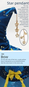 Detail of blue velvet witch hat featuring 3D gold star charms and a soft yellow mesh bow