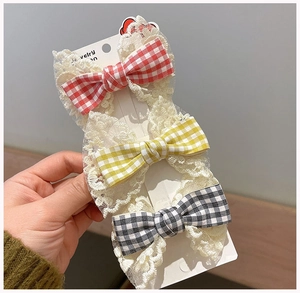 Three-piece set of plaid bow hair clips with white lace trim on display card