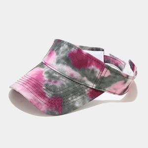Detail of pink and grey tie-dye sun visor with adjustable velcro strap and wide brim