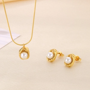Elegant gold stainless steel jewelry set with lava-textured pendants and white pearls