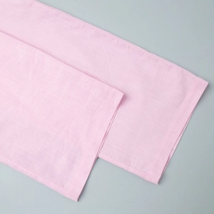 Detaillierte Nahaufnahme der rosa Leinentextur und sauberen Nähte an der weiten Hose