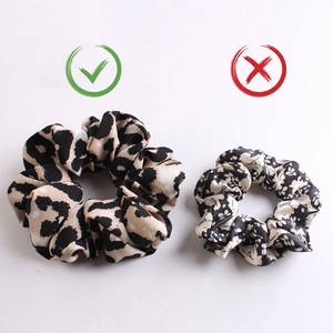 Comparison showing large silk leopard print scrunchie versus small low-quality hair tie