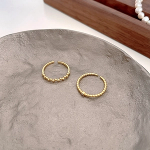 Close-up of gold-plated 925 silver adjustable rings with beads and zircon accents