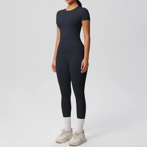 Close-up of black breathable yoga set with short sleeve top and high-waist leggings