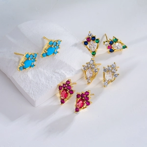 Detail view of four pairs of gold plated stud earrings with zircon and colored gemstones