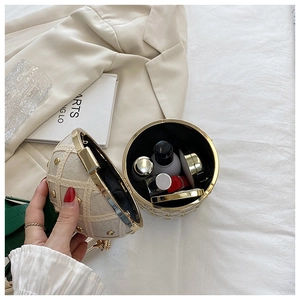 Detailed interior of spherical ball clutch bag showing cosmetic storage capacity