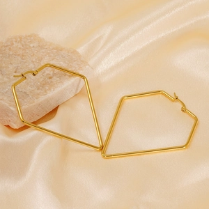 Minimalist geometric gold-plated titanium earrings with a kite-shaped design on satin