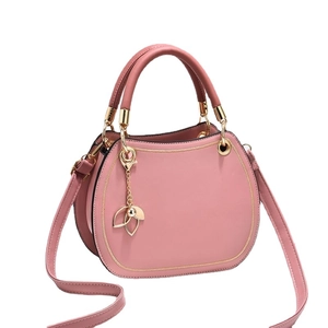 Pink semi-circular handbag for women with golden petal pendant and adjustable strap