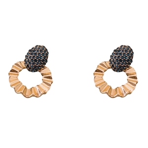 Elegant gold earrings with navy pave stones and wavy rings on white background