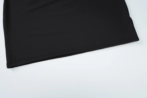 Detail of precise double-needle stitching and fine fabric texture on black garment hem