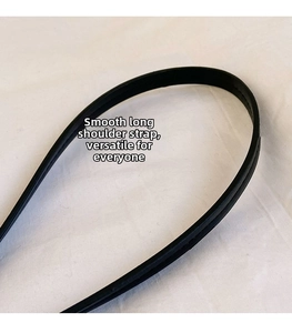 Detail of smooth black leather shoulder strap with neat edge stitching and fine texture