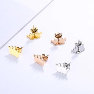 Golden, rose gold, and silver crown stud earrings set on a clean white background
