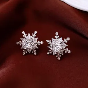 Elegant silver hexagonal snowflake stud earrings with sparkling cubic zirconia inlay