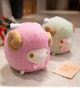 Close-up of pink and green plush sheep toys with fluffy texture and bow details